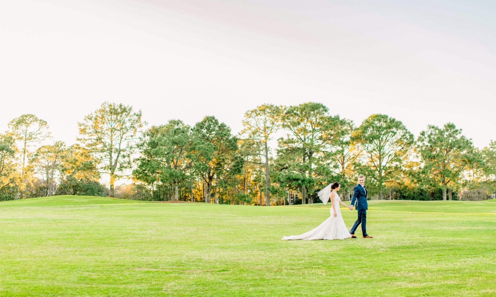 A bride and groom on the lush green grass at hotel effie