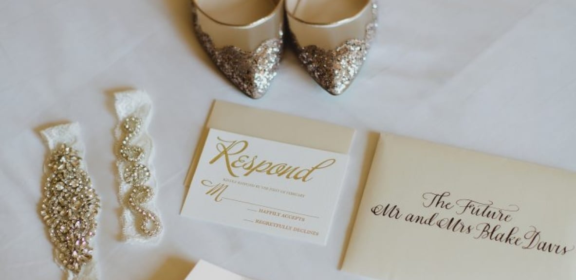 Bridal shows, jewelry and a wedding invitation.