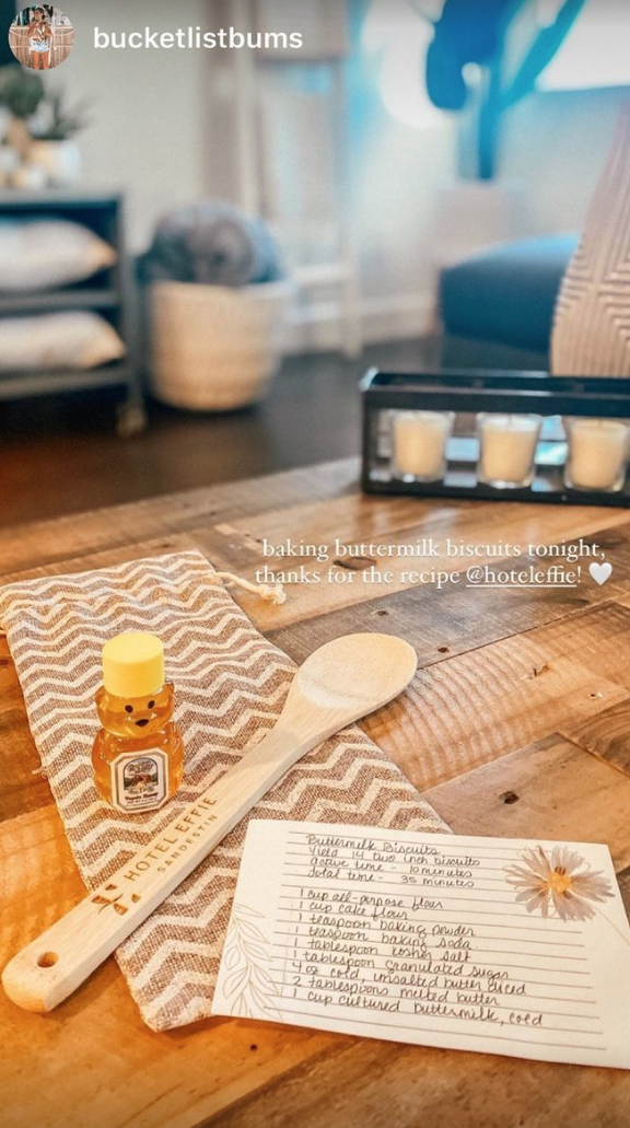 a recipe card, wooden spoon, and honey on a wooden table