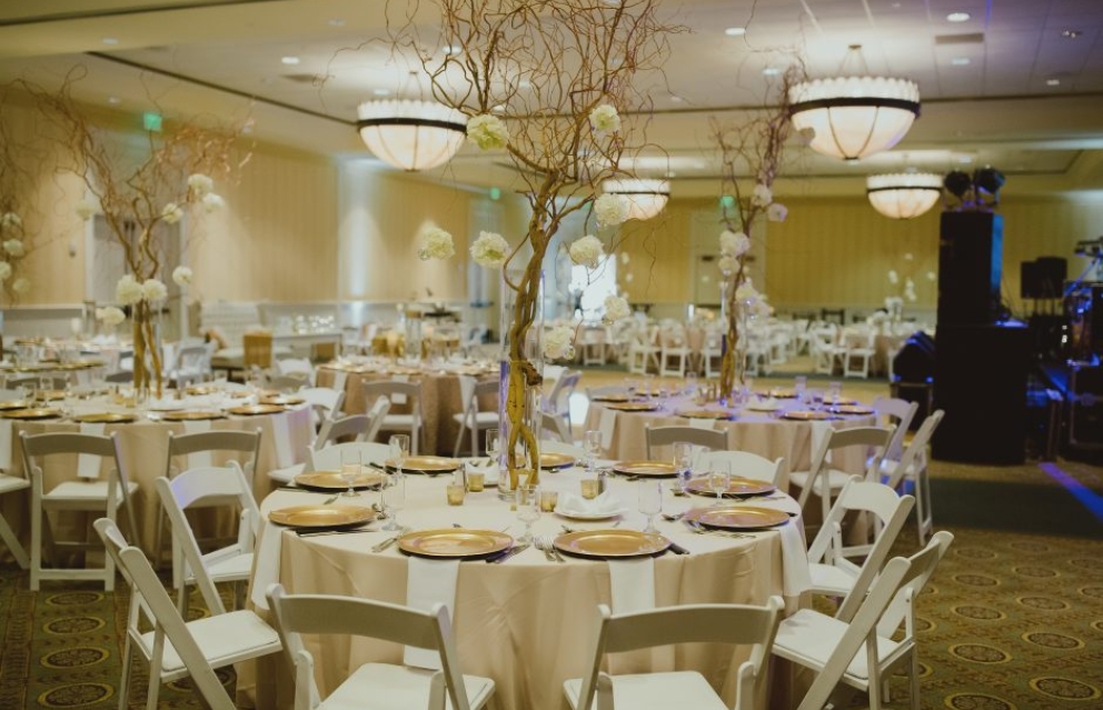 Tables are set in Hotel Effie for a wedding dinner.