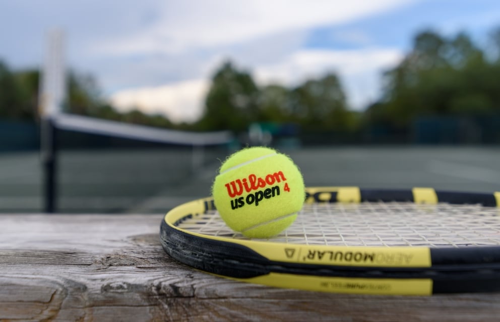 tennis ball on racket