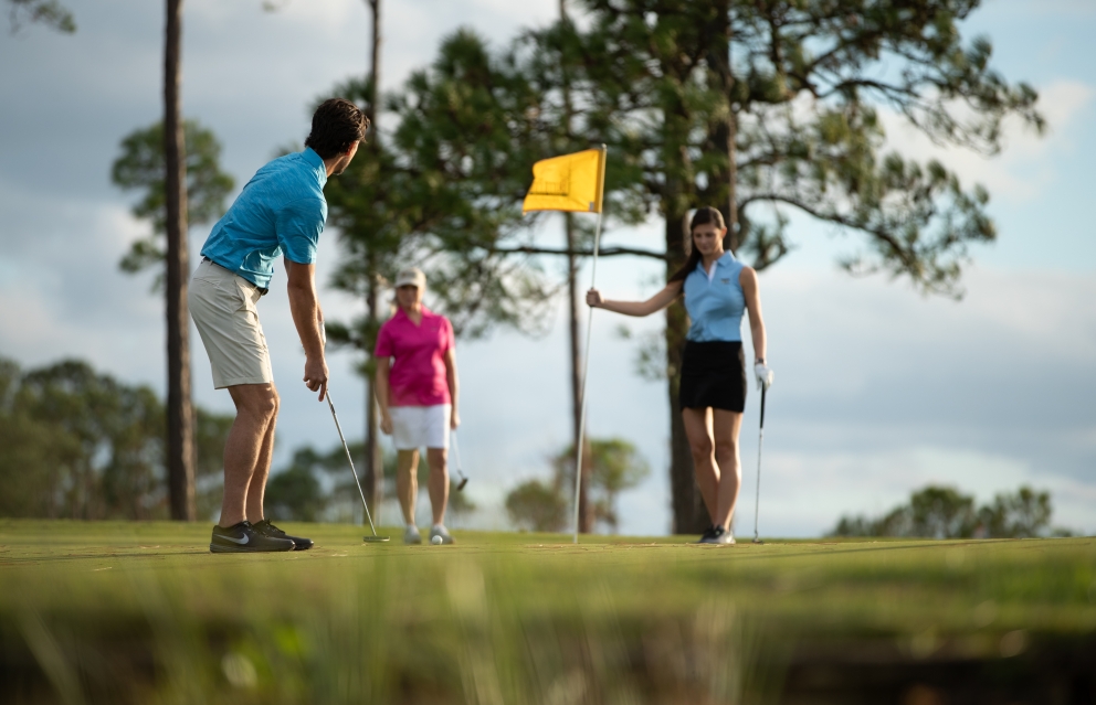 Three people putting