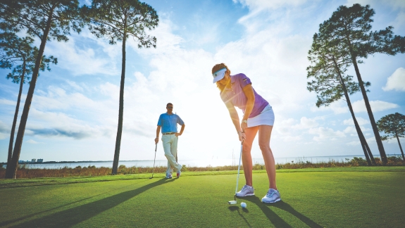 A couple playing a round of golf on a Florida golf course.