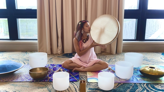 woman on floor conducting sound healing