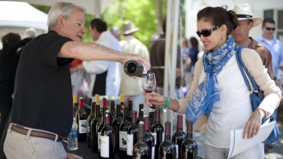 Man pouring woman a glass of wine