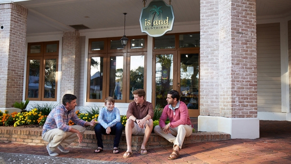 Men sitting in front of store