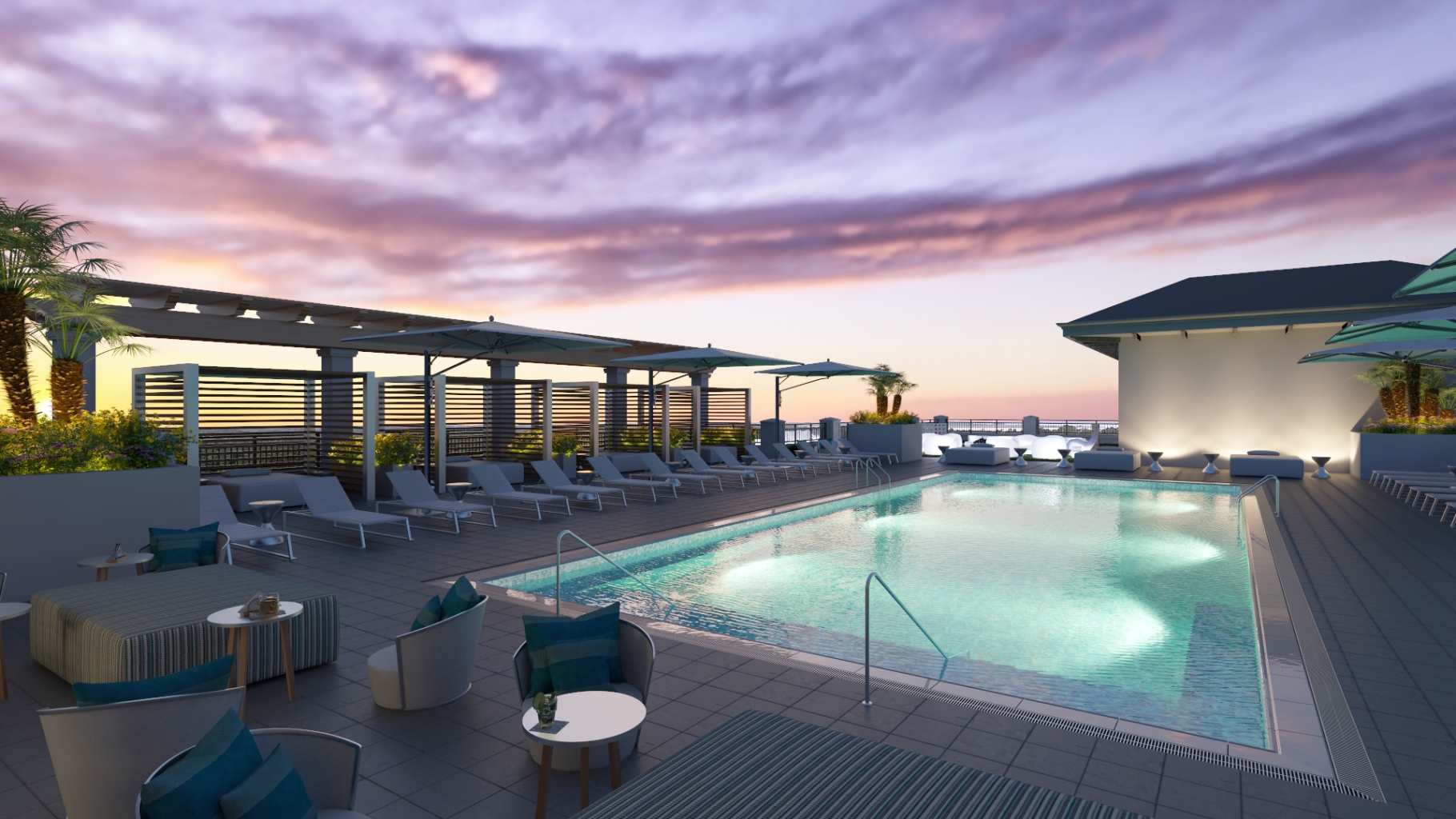 The Ara rooftop pool and lounge feature a lit of pool below a sunset coloured sky.