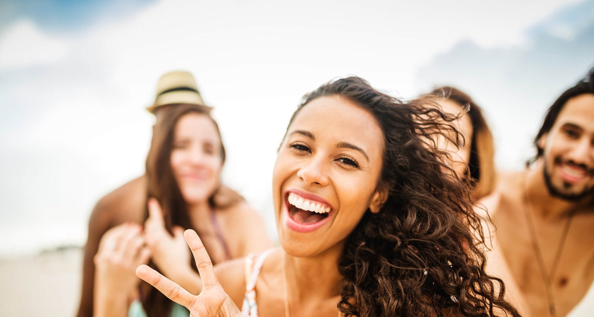 A group of young individuals laughing and smiling.