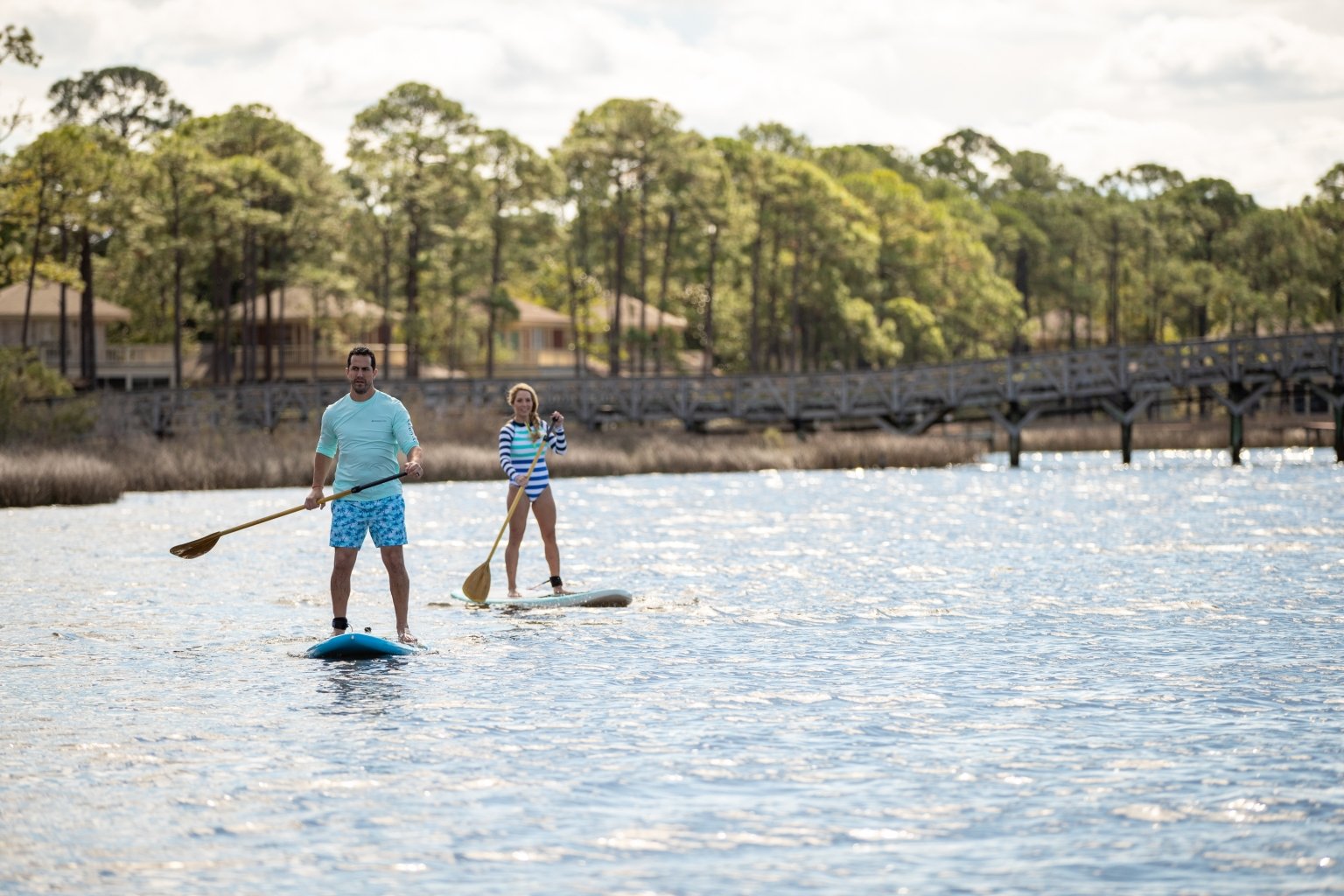 a couple paddleboarding 