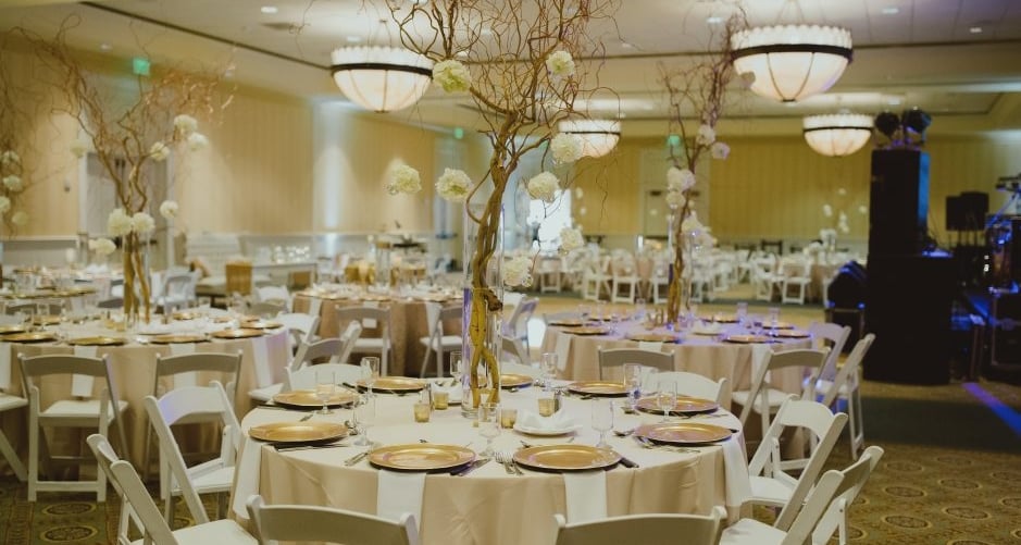 Tables are set in Hotel Effie for a wedding dinner.