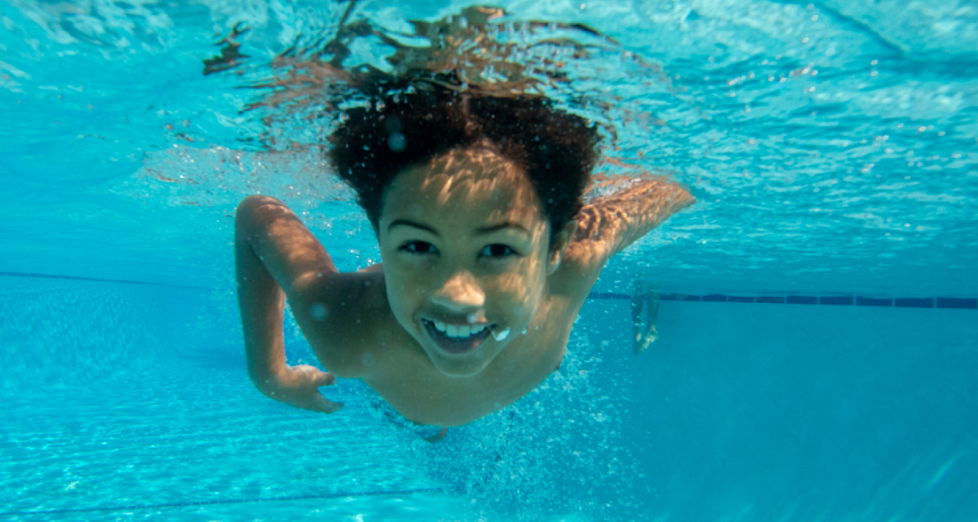 an underwater photo of a boy swimming