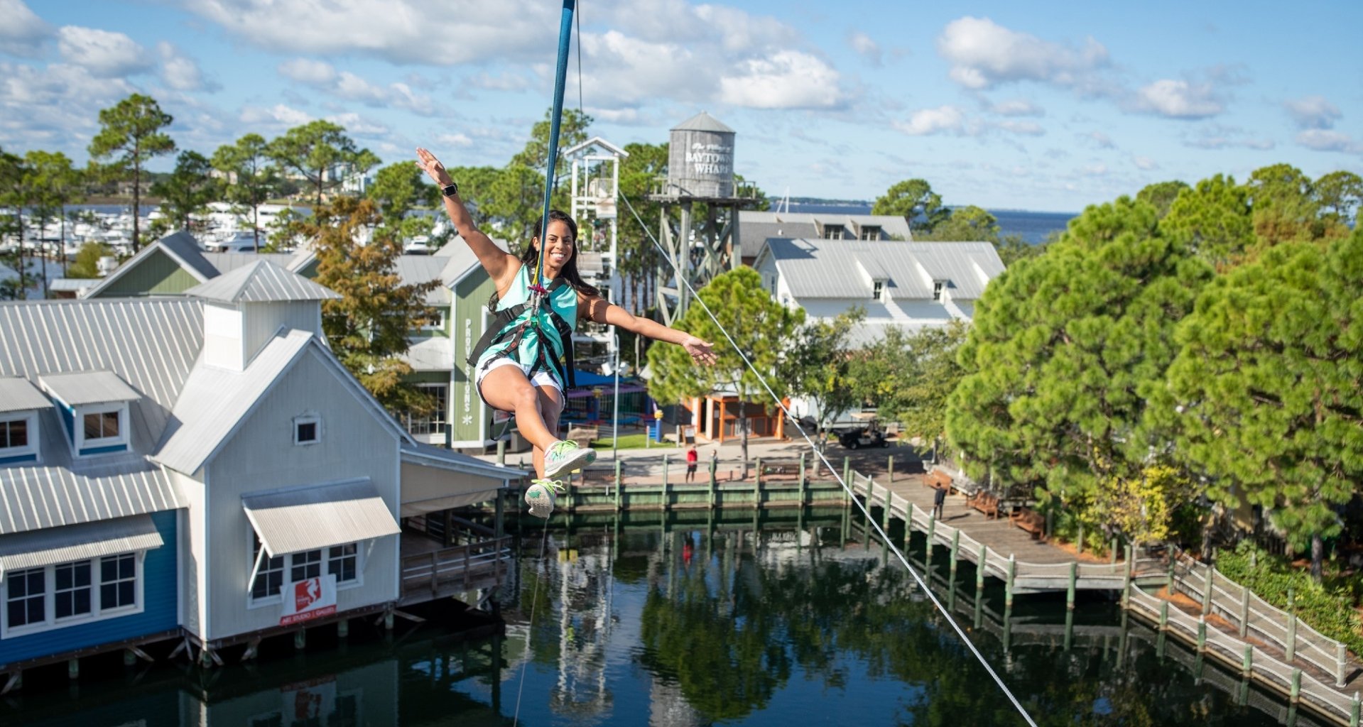 A woman ziplining at Baytowne Wharf.