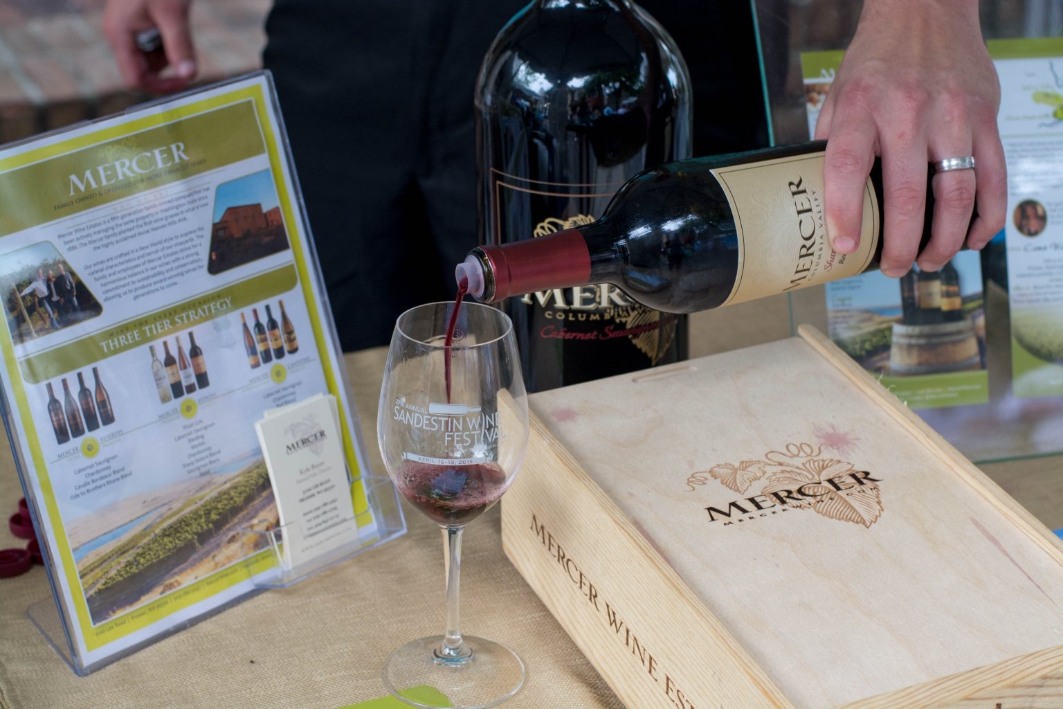 A sommelier pours a glass of Mercer red wine