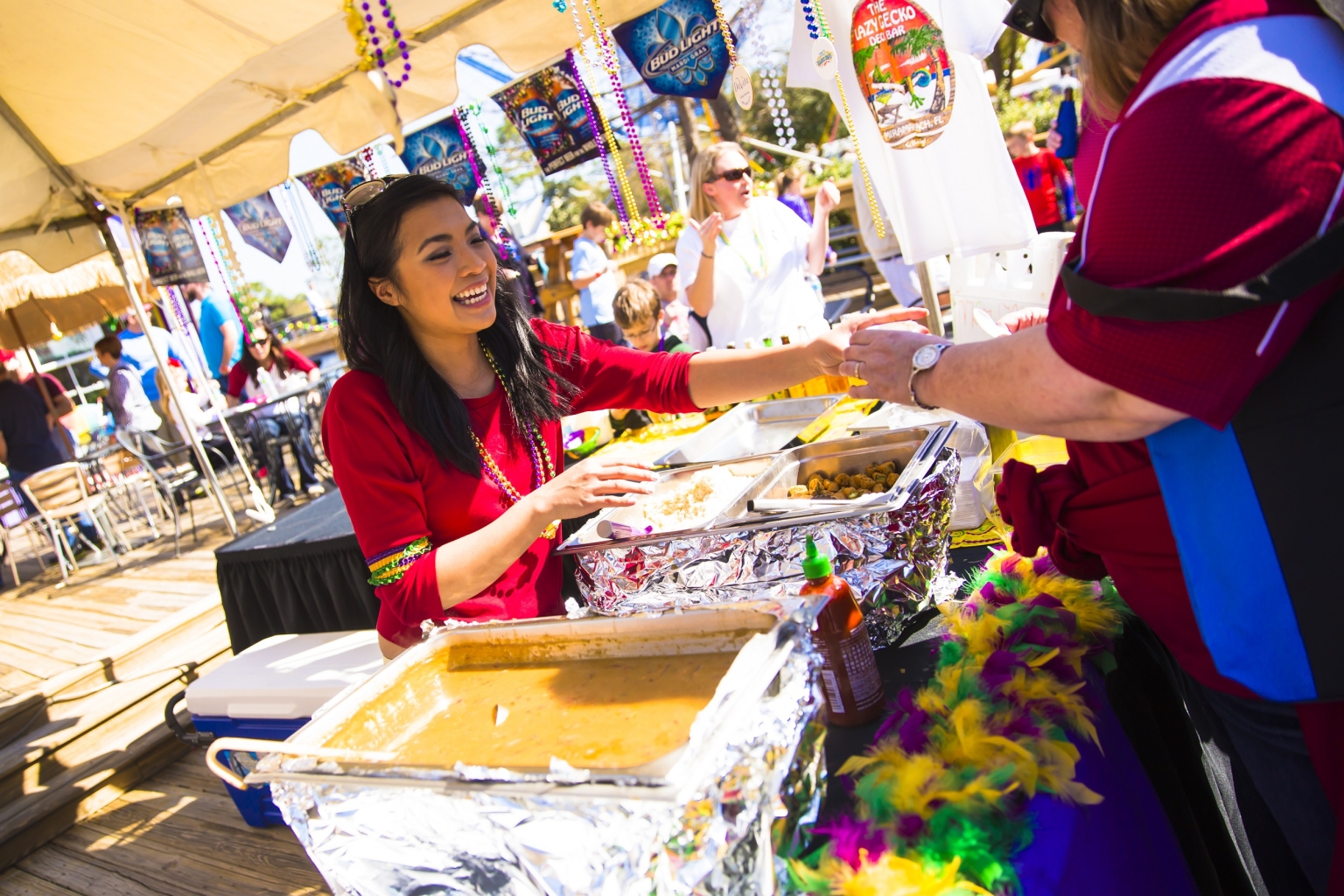A woman serves food to a festival attendee