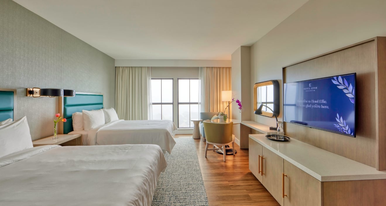 A Hotel Effie guest room with two queen beds.