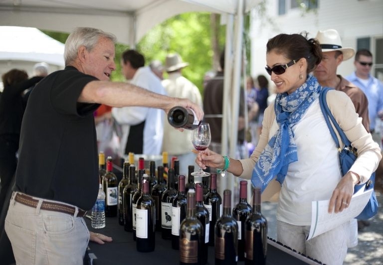 Man pouring woman a glass of wine