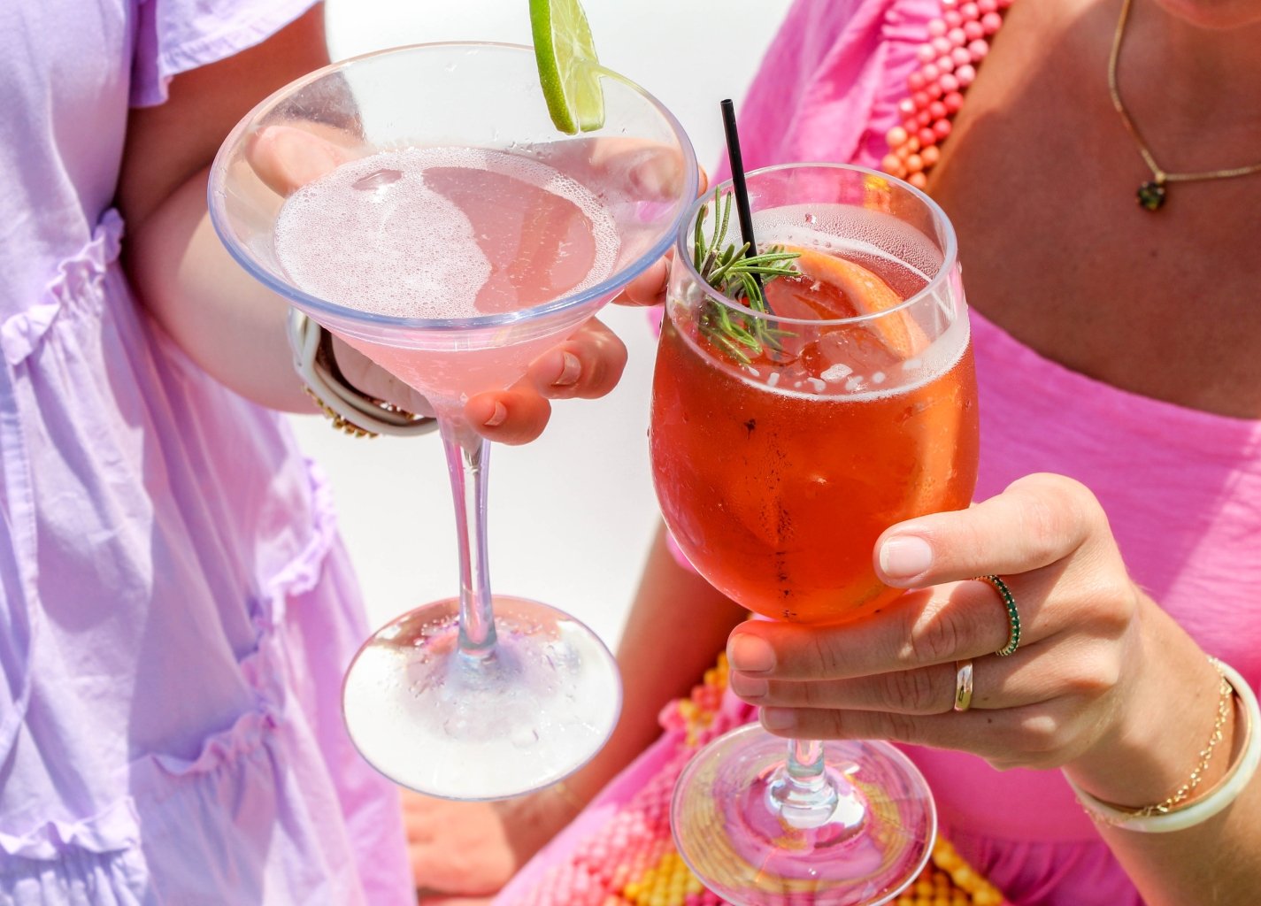 cheers with cocktails at ara