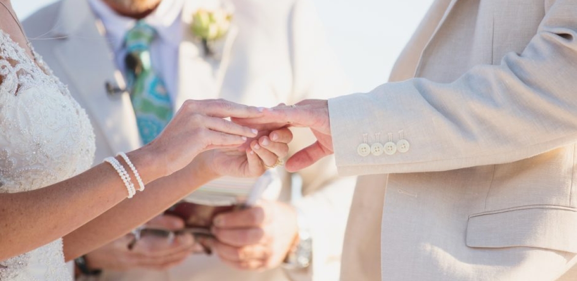 Close up of a couple exchanging vows on a Florida beach.