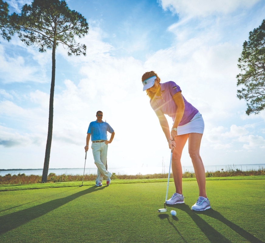 A couple playing a round of golf on a Florida golf course.